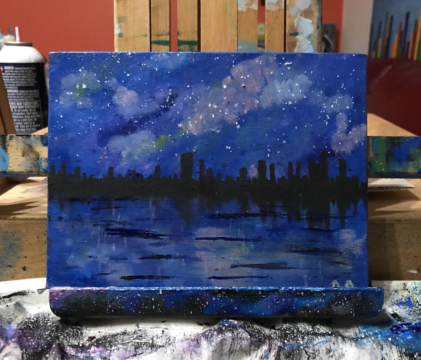 Original oil paintings of city skyline over a lake/river on a starry night